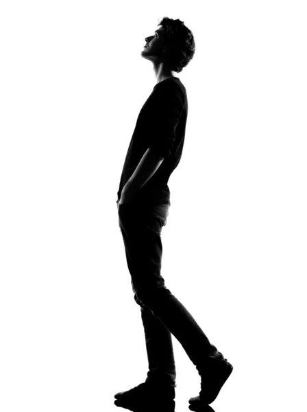 Young man silhouette walking looking up — Stock Photo, Image