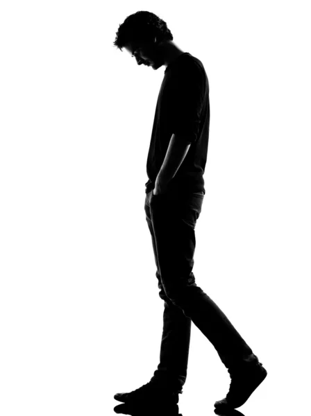 Young man silhouette sad walking — Stock Photo, Image