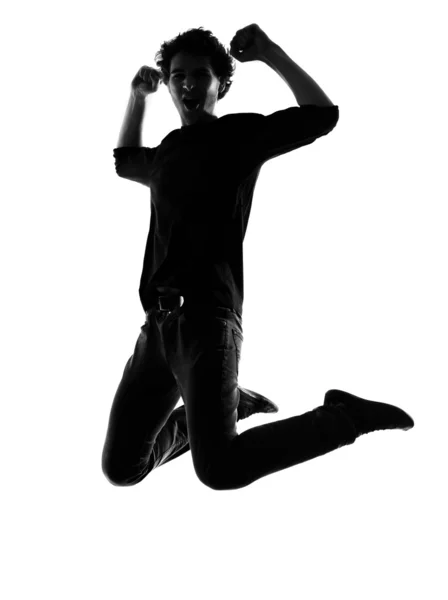 Sziluettjét jumping boldog a fiatalember — Stock Fotó