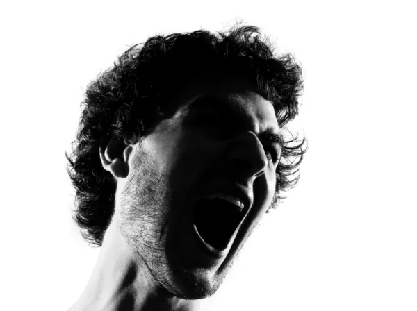 Jovem silhueta gritando retrato zangado — Fotografia de Stock