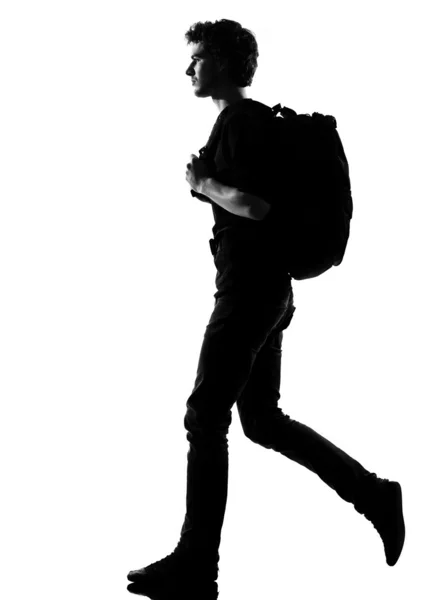 Jovem homem silhueta mochileiro andando — Fotografia de Stock