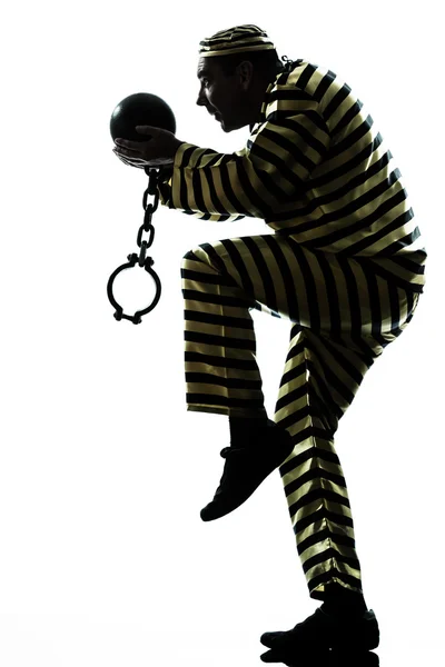 Hombre prisionero criminal con bola de cadena escapando Fotos de stock libres de derechos