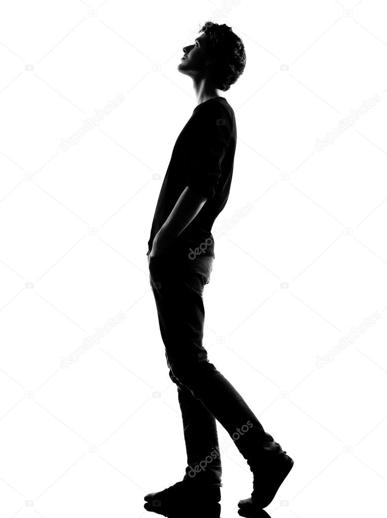 Young man silhouette walking looking up