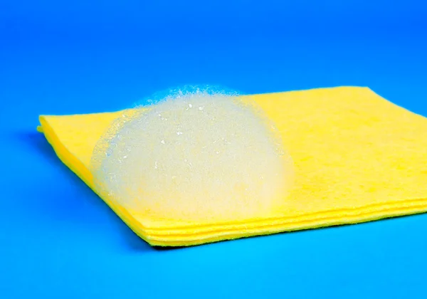 Yellow microfiber duster with foam — Stock Photo, Image