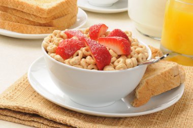 Cold cereal topped with strawberries clipart