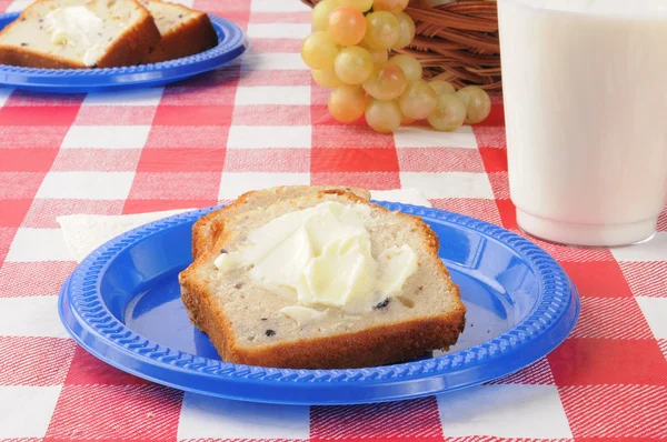 ブルーベリーのパンと牛乳、ピクニック テーブルの上 — ストック写真