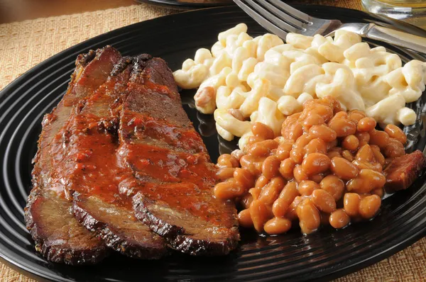 Closeup up of beef brisket with baked beans — Stock Photo, Image