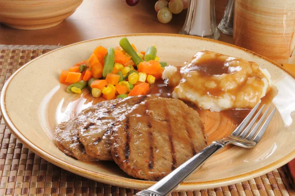 Salisbury steak dinner with mixed vegetables — Stock Photo, Image