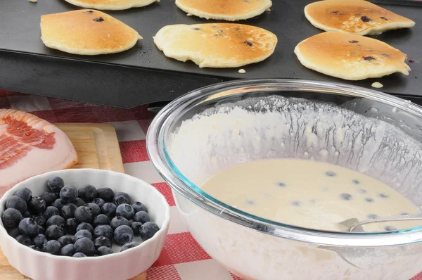 Blueberry pancakes cooking on the grill — Stock Photo, Image