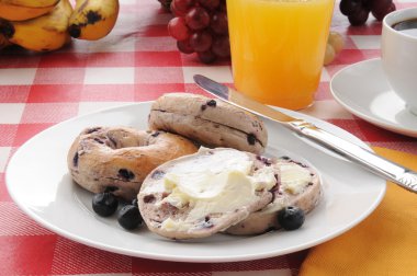 Blueberry bagles with orange juice clipart