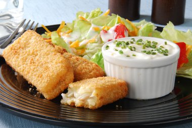 Closeup of fish sticks with salad clipart