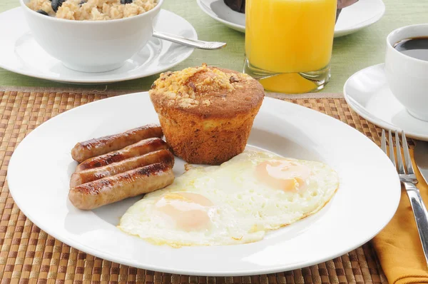 Sausage and eggs with coffee cake — Stock Photo, Image