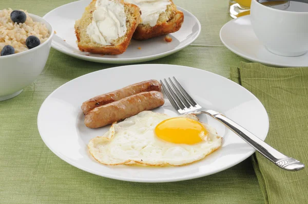 Sausage and eggs with coffee cake — Stock Photo, Image