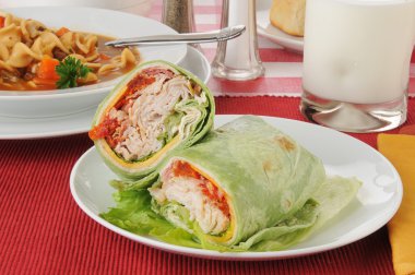 Turkey club sandwich wrapped in a spinach tortilla clipart