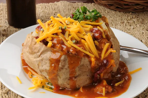 Baked potato with chile and cheese — Stock Photo, Image