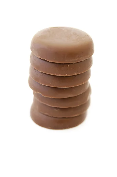Pocas piezas de chocolate sobre fondo blanco —  Fotos de Stock