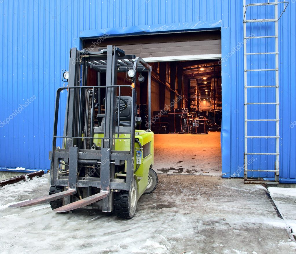 Forklift at large warehouse — Stock Photo © maxoidos 11452922