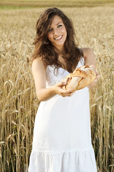 Улыбающаяся девушка предлагает хлеб — стоковое фото