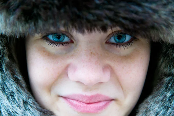Cute girl with freckles who wear a fur hat — Stock Photo, Image