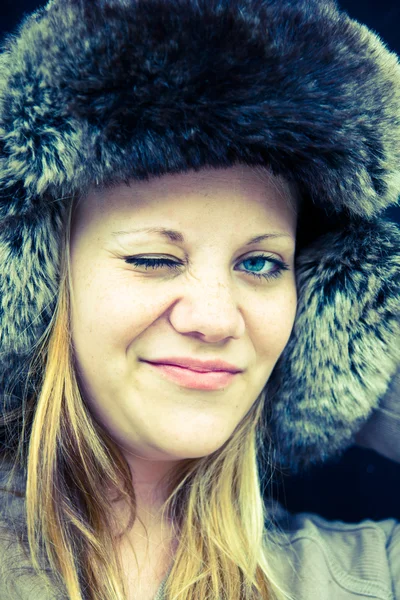 Flirting woman in a fur hat — Stock Photo, Image