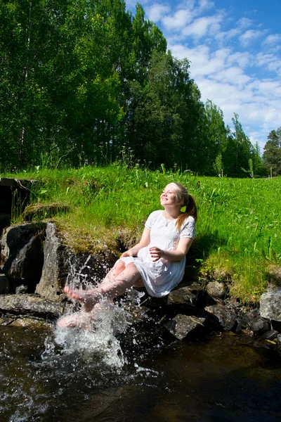 stock image Young woman laughing and splashing