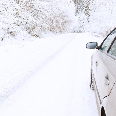 Car on snowy winter road clipart