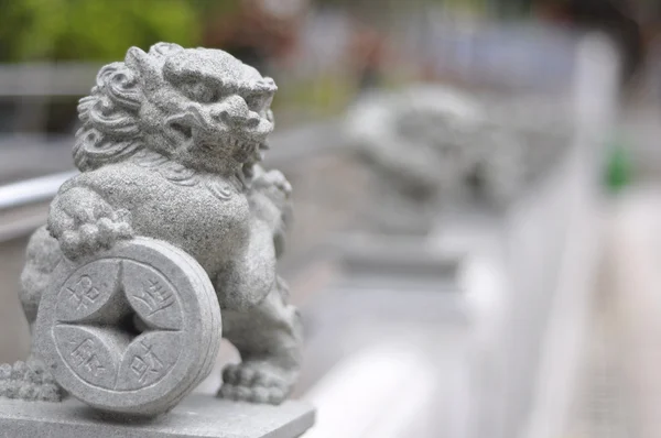 Chinesische Löwengottheit mit alter Münze — Stockfoto