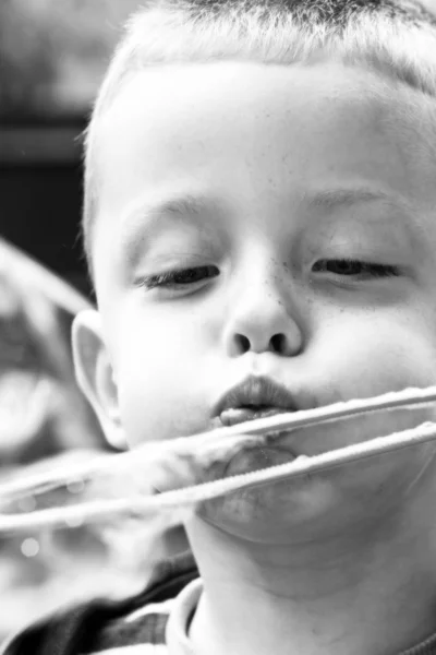 Boy blowing bubbles — Stock Photo, Image