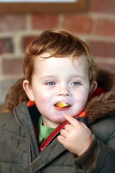 Little boy eating a chip — Stock Photo, Image