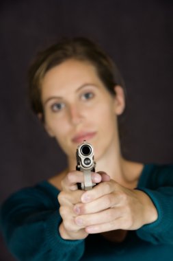 Woman defending herself with handgun clipart