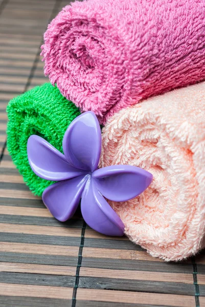 Wellness-Handtücher Rollen und Blume. lizenzfreie Stockfotos