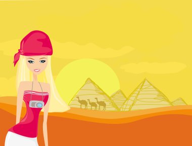 Women on background the pyramids in Giza built for the pharaoh. clipart