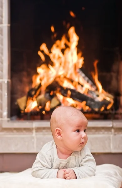 Baby with fireplace — Stock Photo, Image