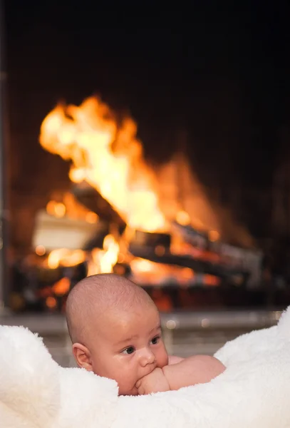 Baby with fireplace — Stock Photo, Image
