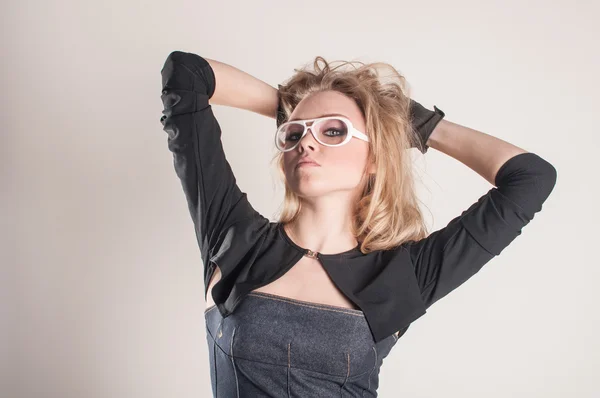 Blond in glasses holds her hair — Stock Photo, Image