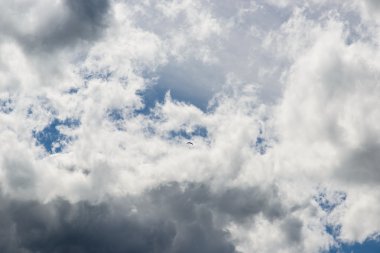 Clouds Formation with tiny paraglider and glider clipart