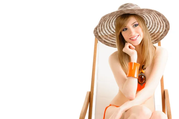 Young woman relaxing on beach chair — Stock Photo, Image