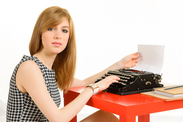 Elegant woman working on typewriter