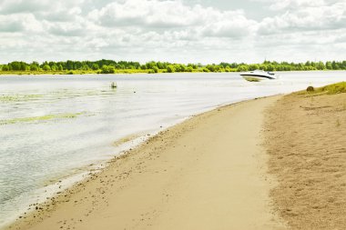 Gorgeous wild beach with white boat clipart