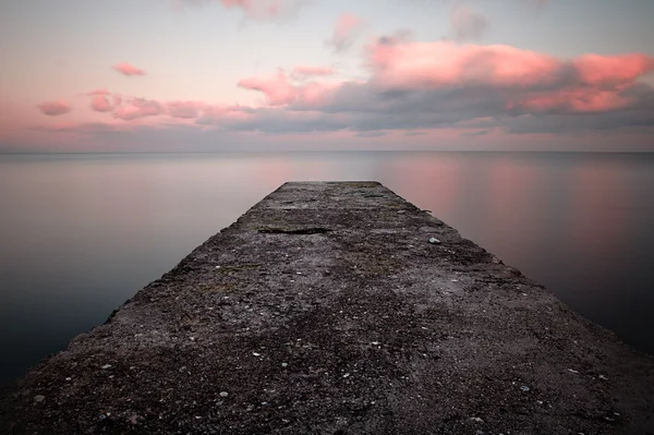 Calm sea sunset with a jetty — Stock Photo, Image