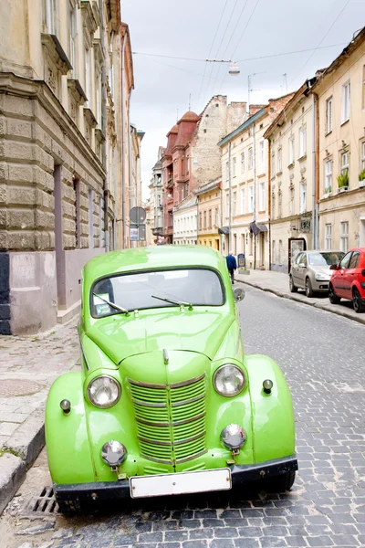 Green retro car on street of Lviv, Ukraine