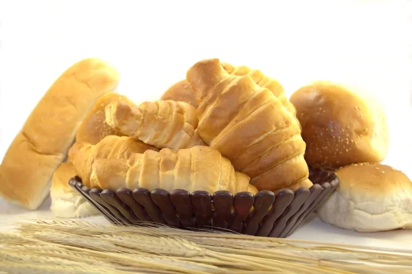 Croissants and rolls in a bread basket — Stock Photo, Image