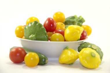 Baby vegetables in white plate clipart