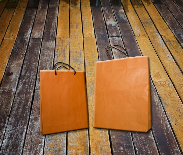 Paper bag on wooden floor — Stock Photo, Image