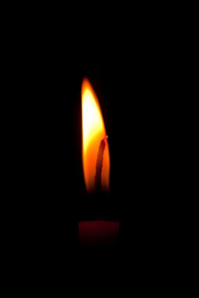 Closeup of burning candle isolated on black background — Stock Photo, Image