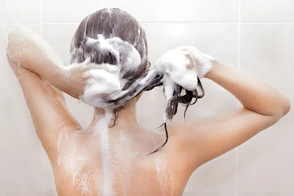 Женщина моет голову — стоковое фото