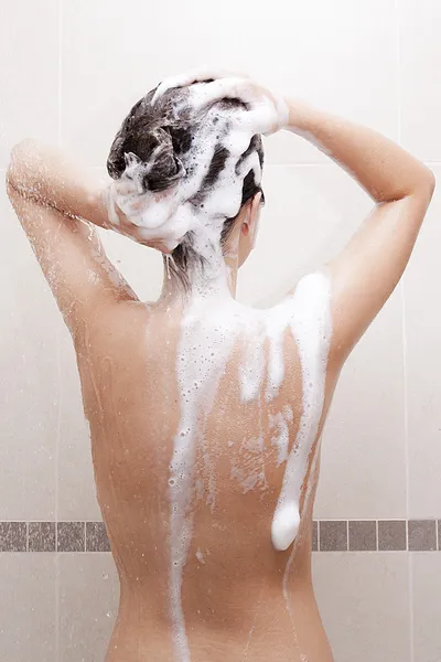 Kvinna tvätta håret Royaltyfria Stockfoton