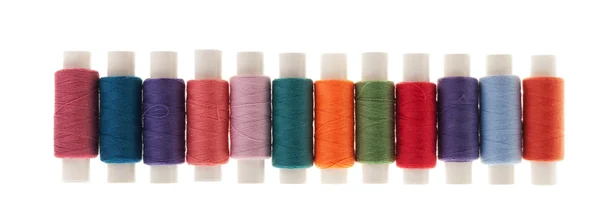 Row of bobbins of thread — Stock Photo, Image