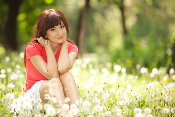 stock image Cute woman in the park with dandelions