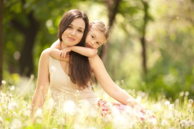 Mother and daughter in the park clipart